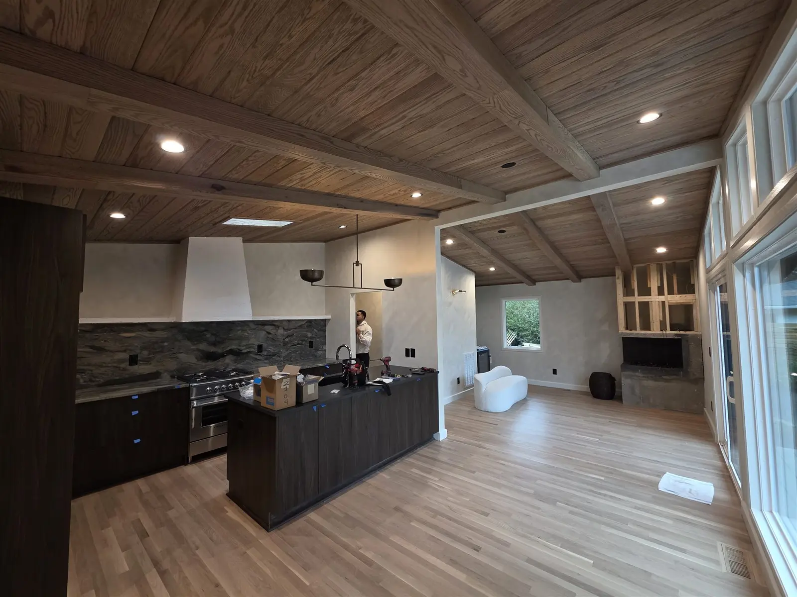 Remodeled kitchen and living space with recessed and decorative lighting