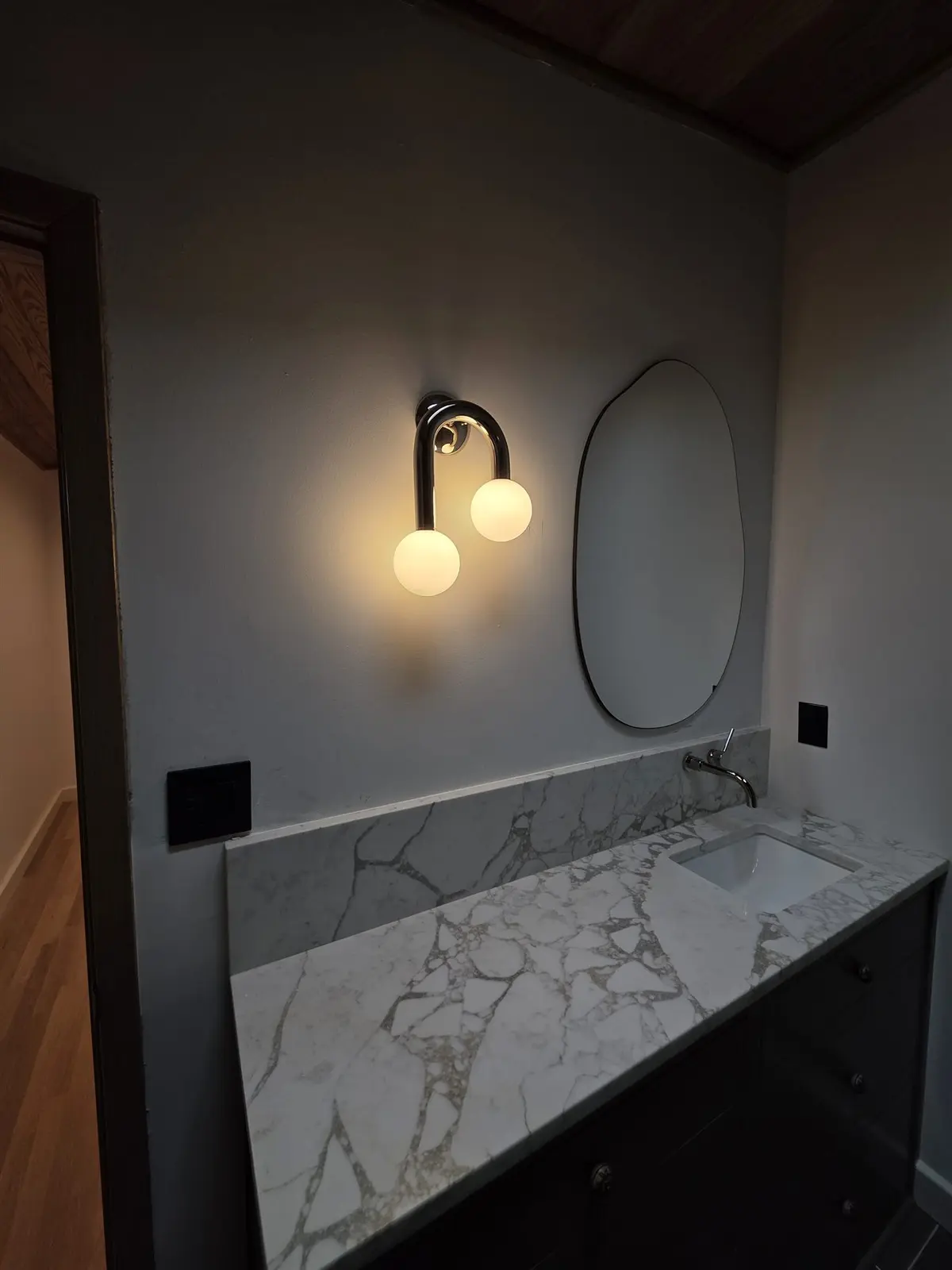 Finished vanity with decorative wall sconce, switches and receptacles