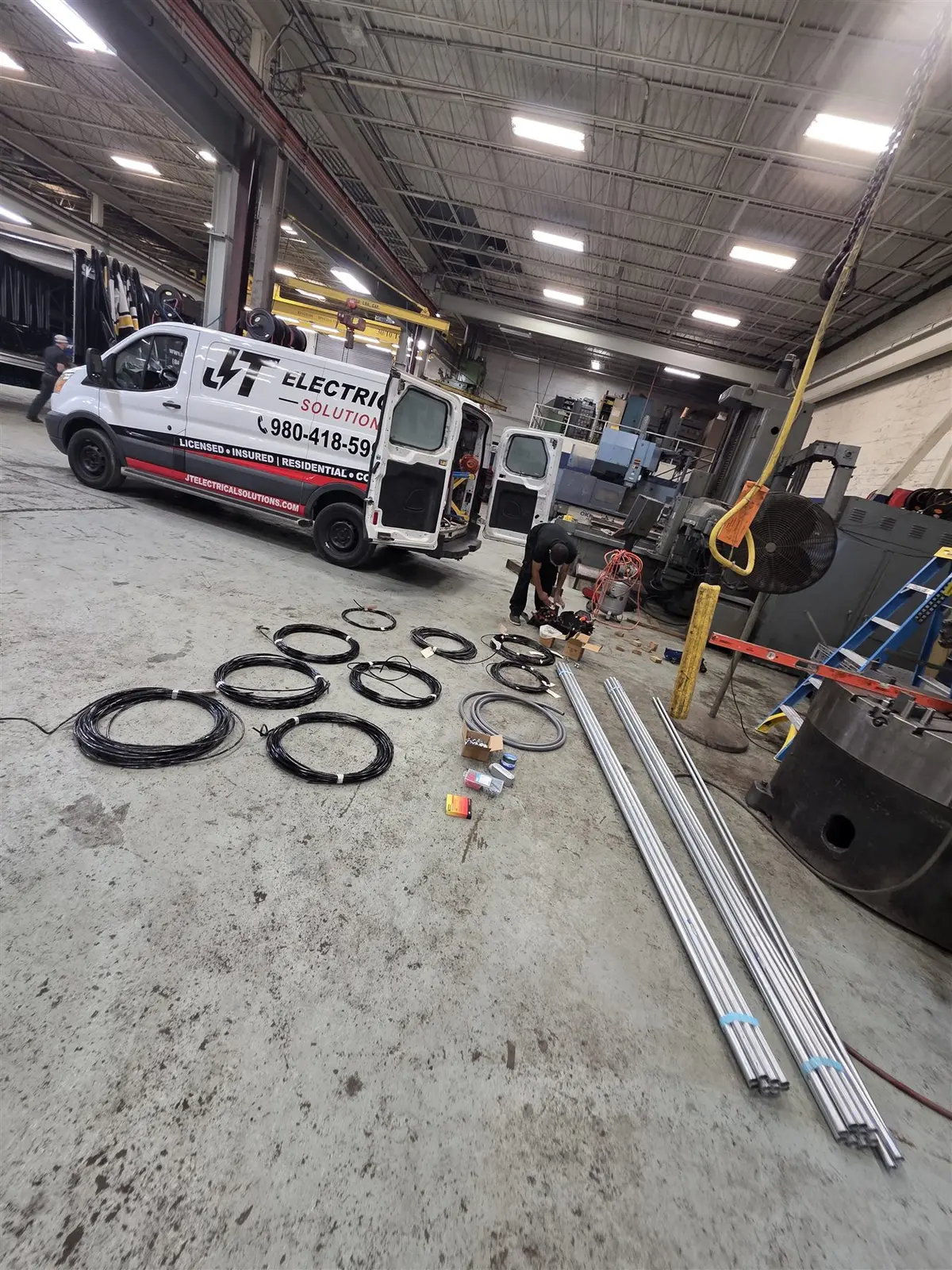 JT Electrical Solutions commercial crew and service van on an industrial jobsite