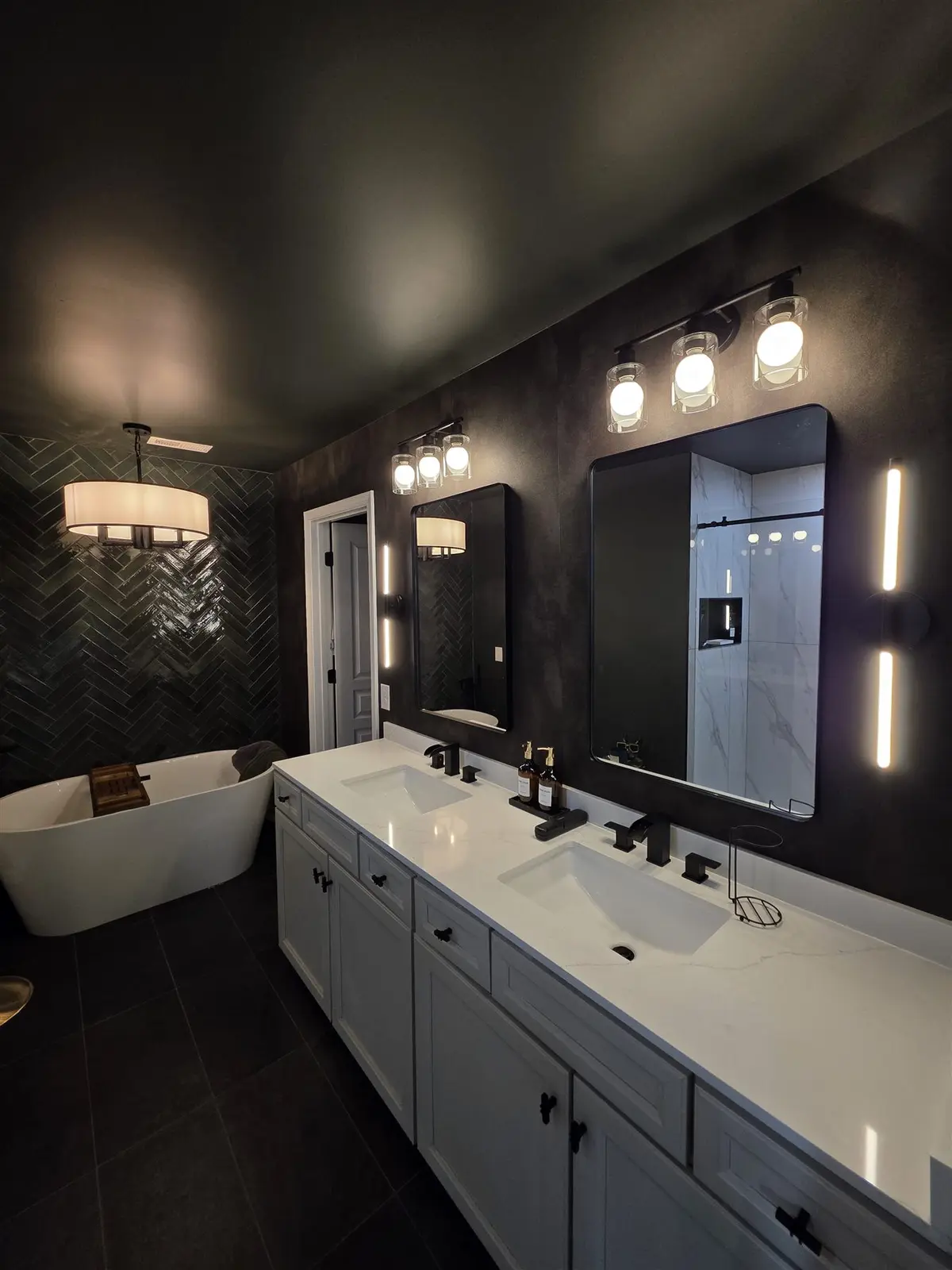Finished luxury bathroom with layered vanity and decorative lighting