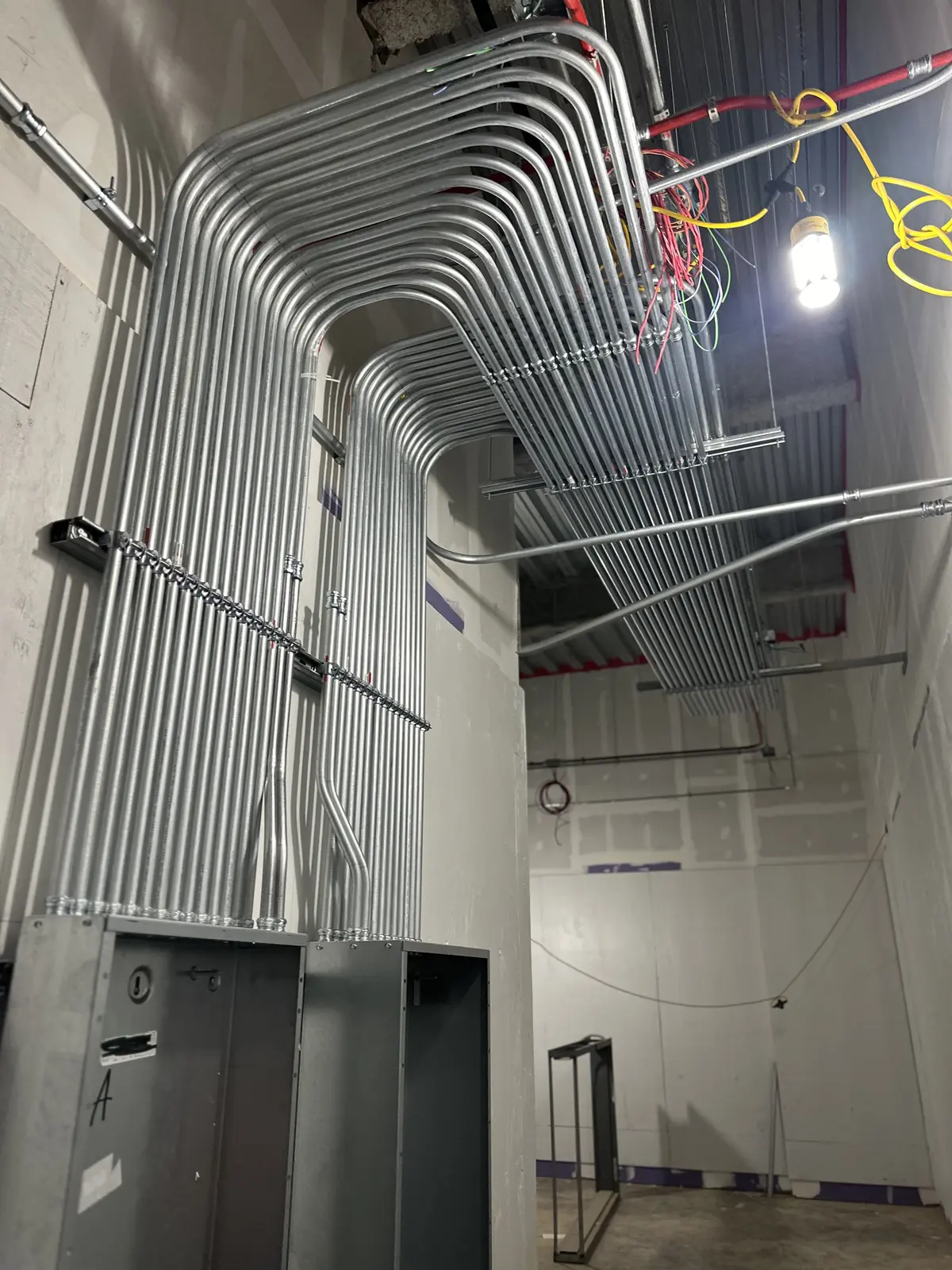 Clean parallel EMT conduit runs in a Charlotte commercial facility