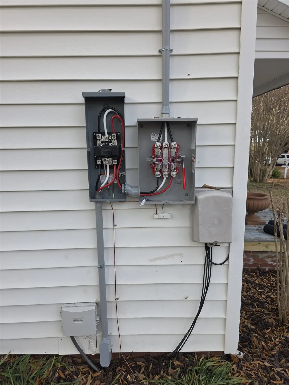 After: completed residential electrical service upgrade with new disconnect and meter equipment